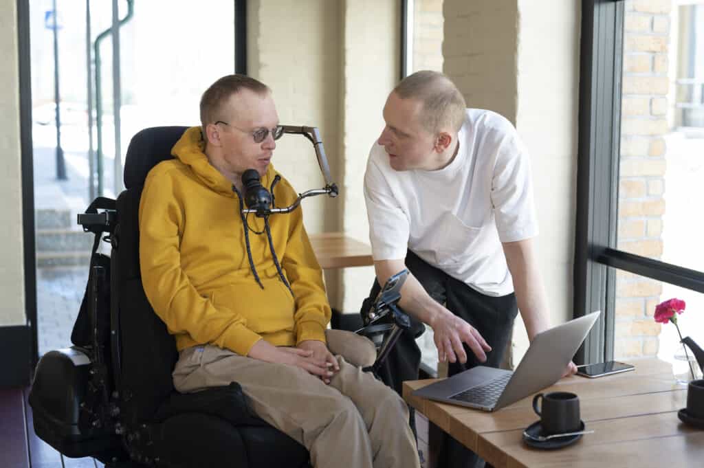 Stock Photo of a person with disability working with another person